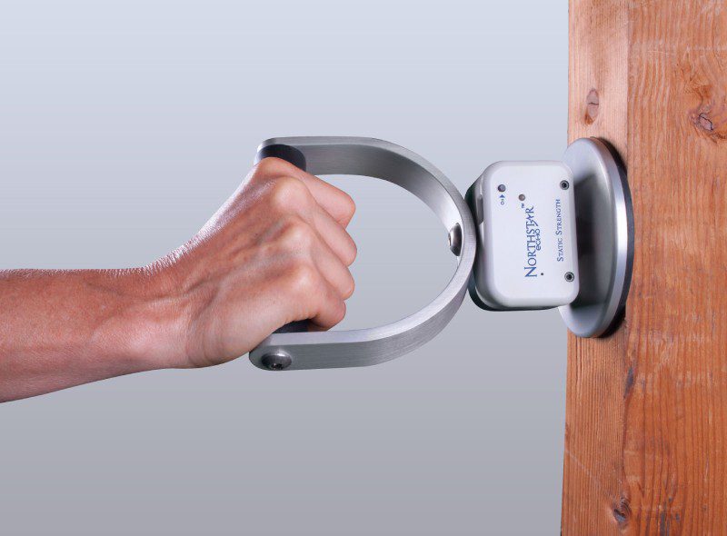 A person holding onto the handle of a device